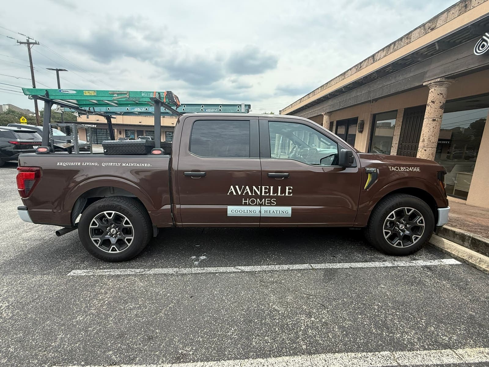 The Avanelle Homes Cooling & Heating truck, a brown pickup with a ladder rack
